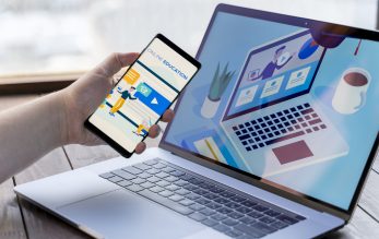 close-up-man-with-smartphone-laptop-indoors-scaled