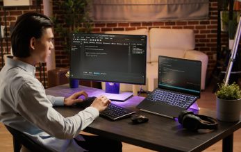 Male system hacker coding security program on pc software